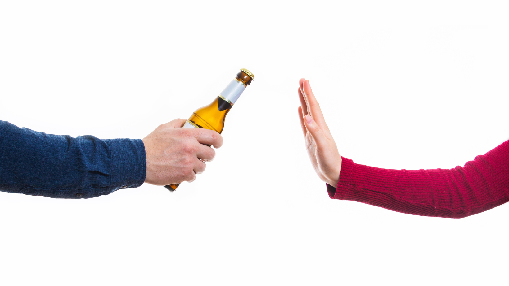 Zdjęcie przedstawiające ręce dw&oacute;ch os&oacute;b, kt&oacute;ra jedna z nich trzyma butelkę z alkoholem